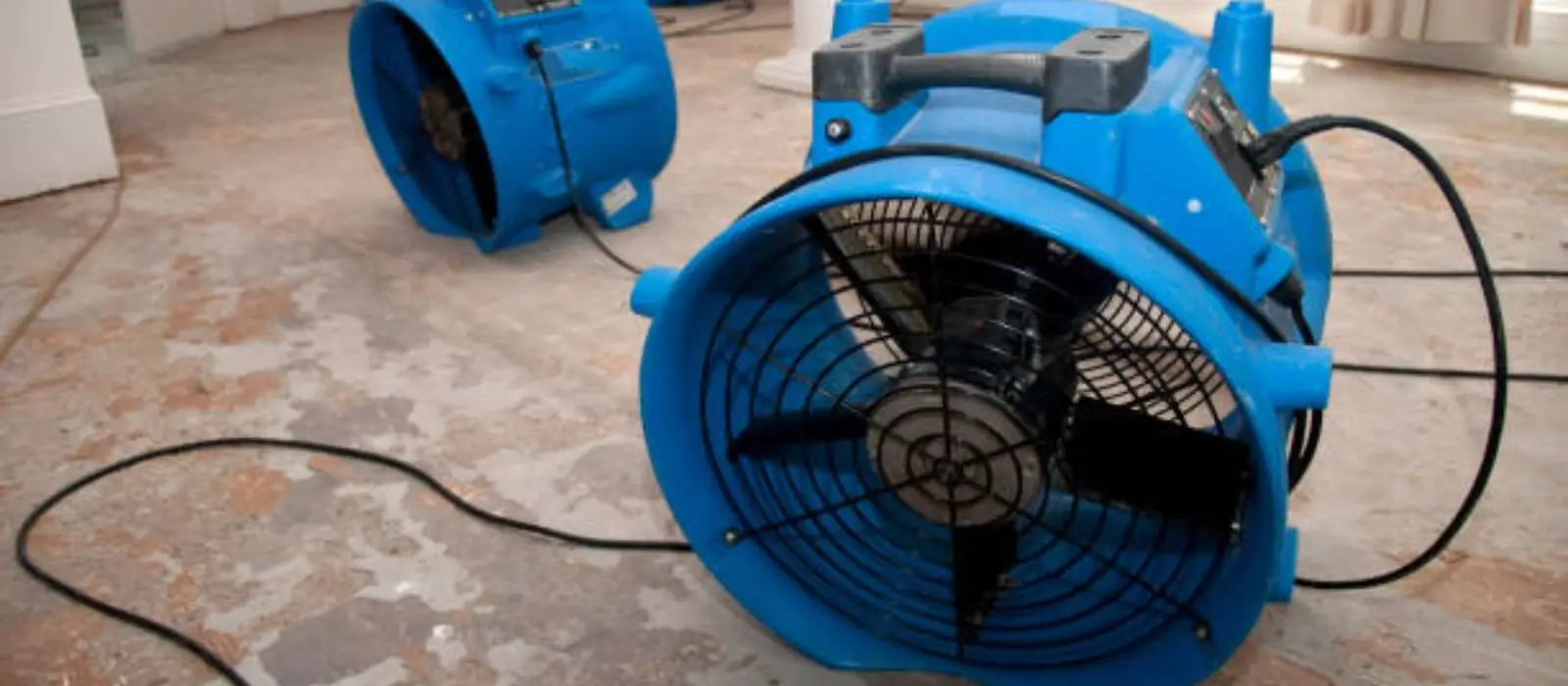 Large blue air mover drying a floor