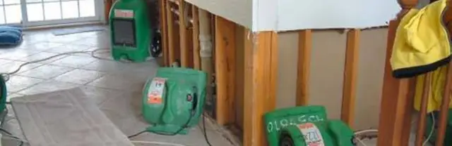 Opened wall cavities and drying fans after water damage